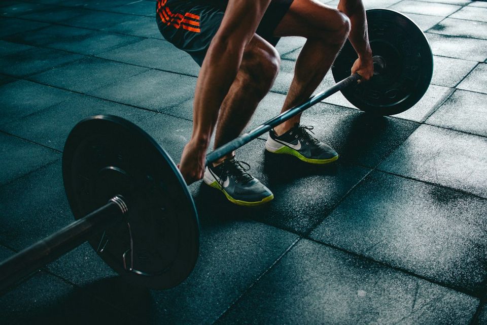 Member performing a weight training lift